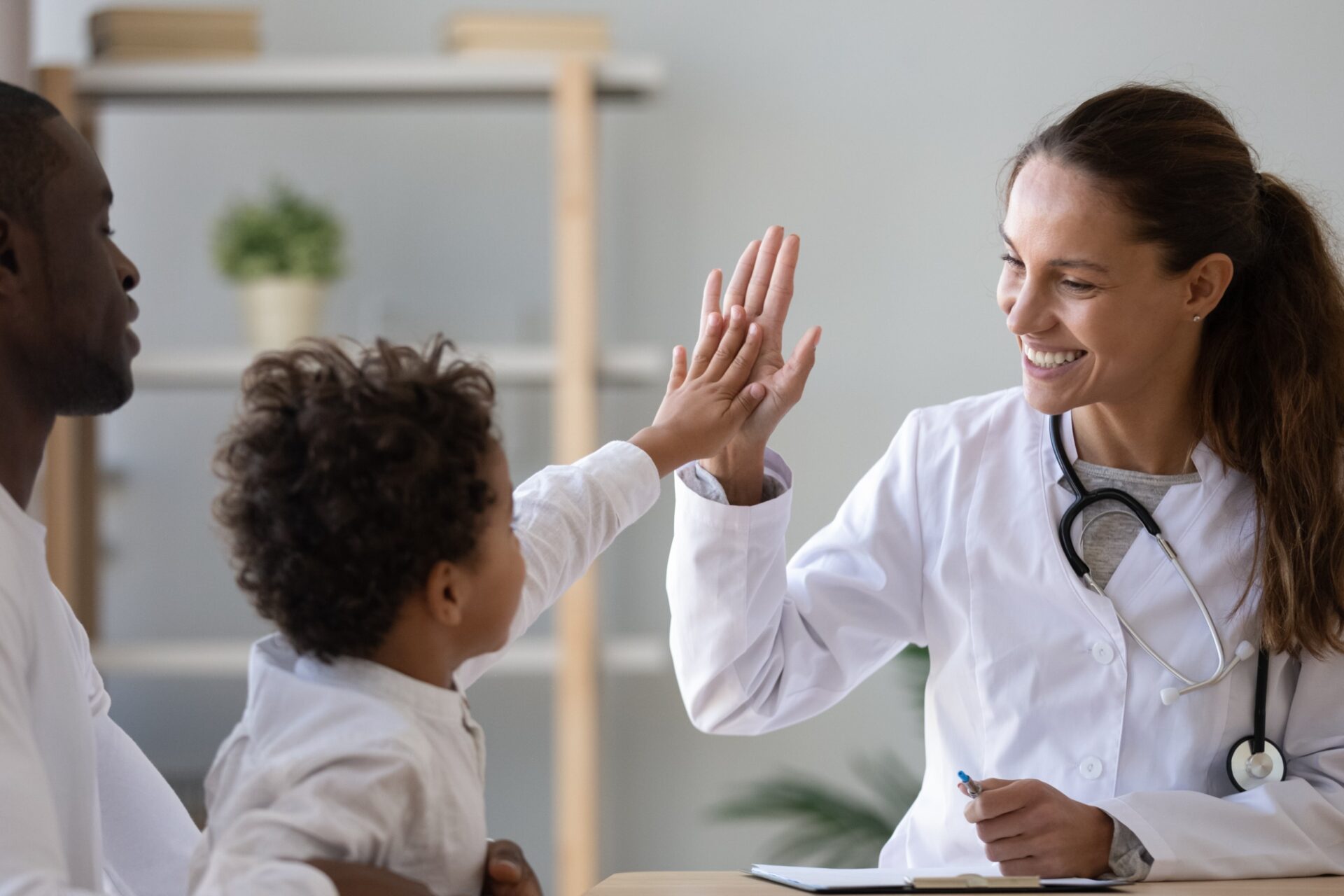 pediatrician high five Pediatrician with toddler and her mom