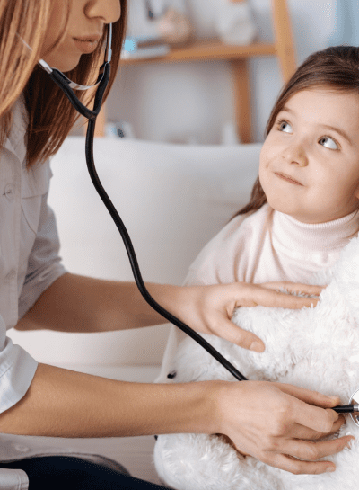 a young girl is being examined by a doctor a young girl is being examined by a doctor